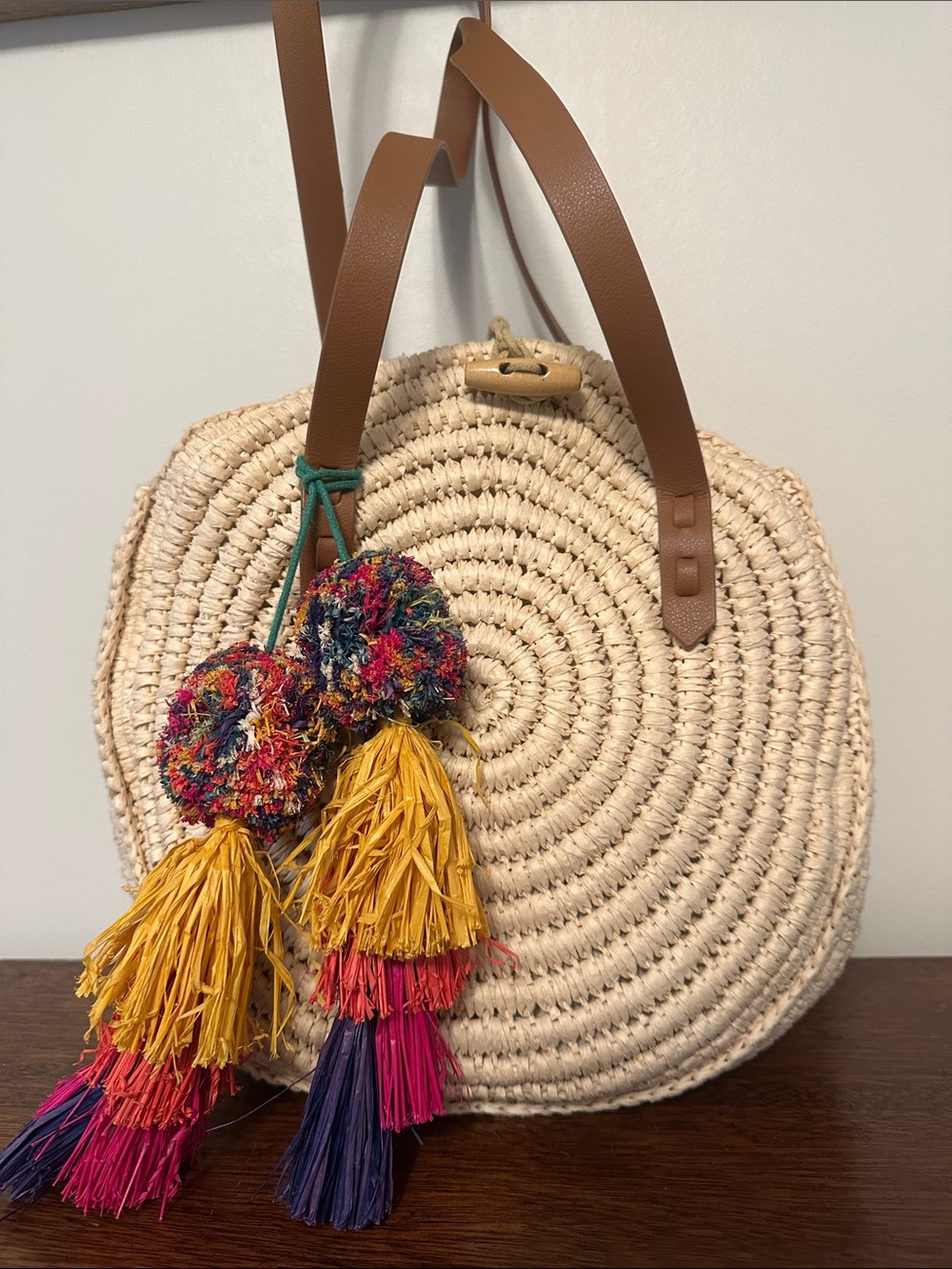 Round Woven Straw Tote with Brown Handles and Multicolor Tassels